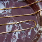 Gold chains on a marbled surface